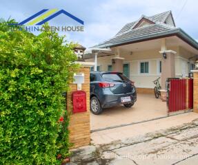 Exterior view of a house with a car parked in the driveway