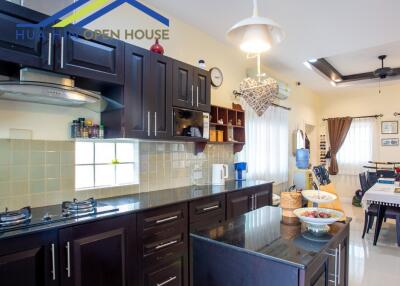 Modern kitchen featuring dark wood cabinets and a kitchen island