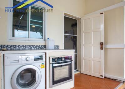 Compact kitchen with essential appliances and washing machine