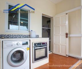 Compact kitchen with essential appliances and washing machine