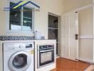 Compact kitchen with essential appliances and washing machine