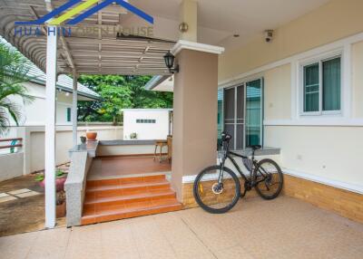 Covered outdoor space with seating and bicycle