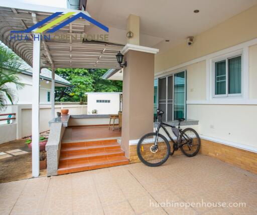 Covered outdoor space with seating and bicycle