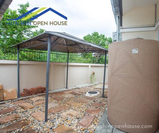 Outdoor area with canopy and water tank