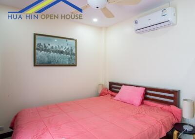 Bedroom with air conditioning and art decoration