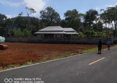 View of a house with surrounding land