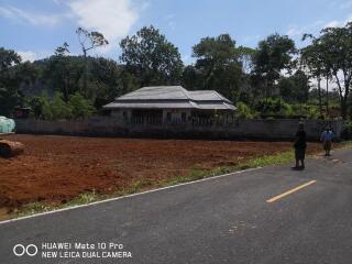 View of a house with surrounding land