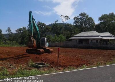 Construction site with building and excavator