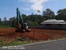 Construction site with building and excavator