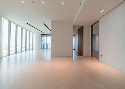 Spacious living room with large windows and modern lighting