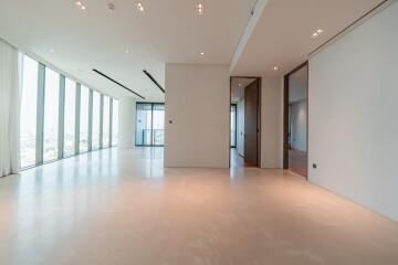 Spacious living room with large windows and modern lighting