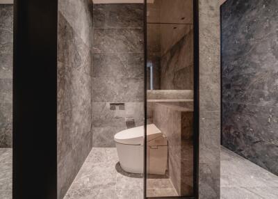 Modern bathroom with marble tiles and smart toilet