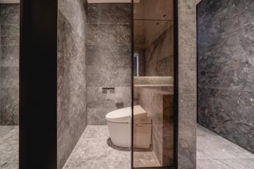 Modern bathroom with marble tiles and smart toilet