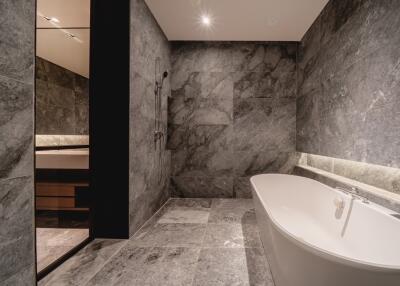 Modern bathroom with marble tiles and a freestanding bathtub