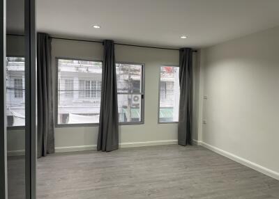 Bedroom with large windows and curtains