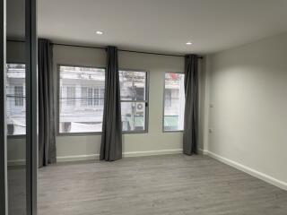 Bedroom with large windows and curtains