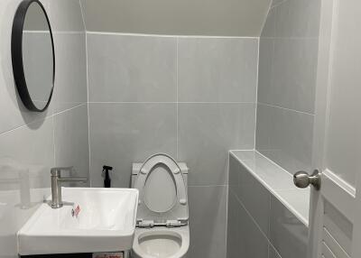 Modern compact bathroom with toilet and sink