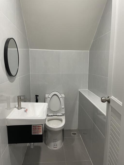 Modern compact bathroom with toilet and sink