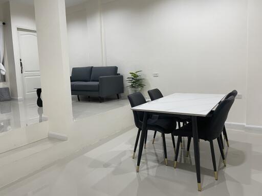 modern dining area with connected living room featuring a sofa