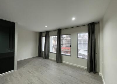 Spacious living room with large windows and modern flooring