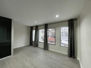 Spacious living room with large windows and modern flooring