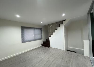 Spacious living area with modern floors and stairs