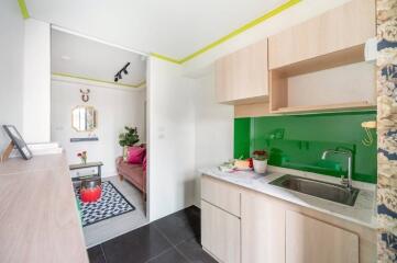 Modern kitchen with adjacent living room area