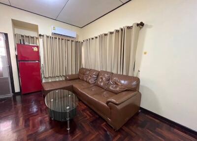 Living room with brown leather sofa and glass coffee table