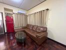 Living room with brown leather sofa and glass coffee table