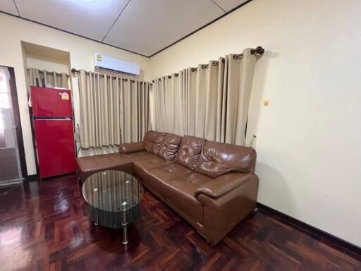 Living room with brown leather sofa and glass coffee table