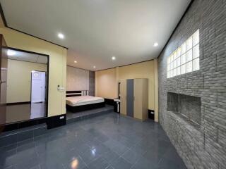 Spacious bedroom with bed, wardrobe, and tiled floor