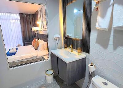 Modern bathroom with window view to bedroom