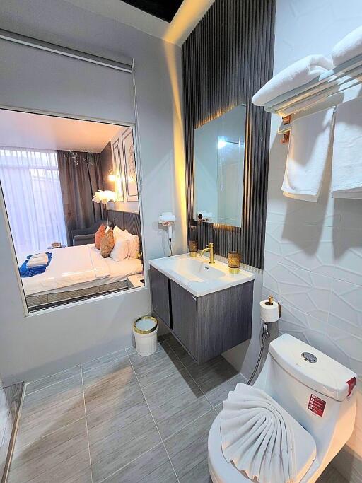 Modern bathroom with window view to bedroom