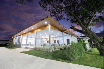 Modern house with large glass windows and surrounding greenery