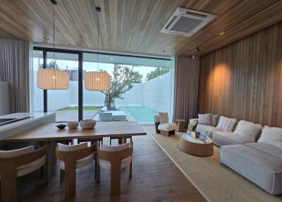 Modern living room with dining area and pool view