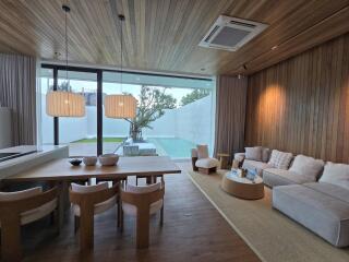 Modern living room with dining area and pool view