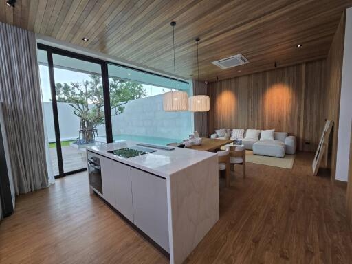 Modern living area with open kitchen and large windows