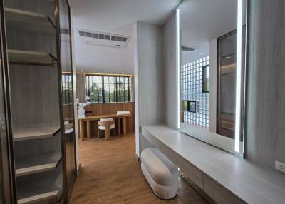 Modern bedroom with built-in shelves and a vanity area