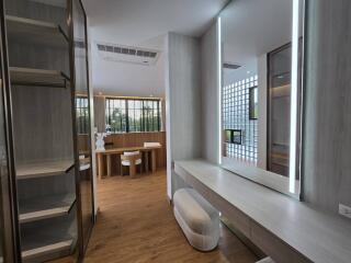 Modern bedroom with built-in shelves and a vanity area