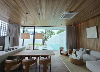 Modern living room with open kitchen and pool view