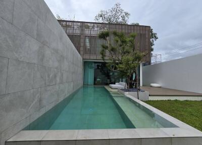 Modern outdoor area with a pool and lounging space