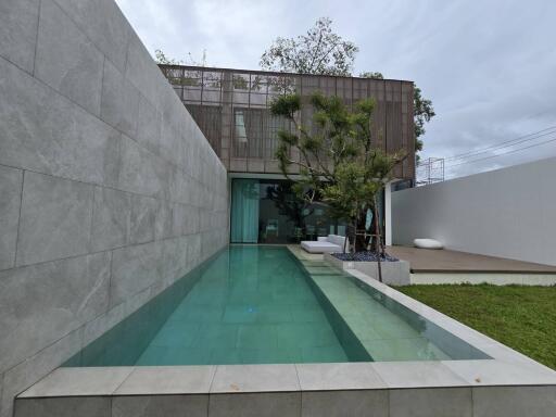 Modern outdoor area with a pool and lounging space