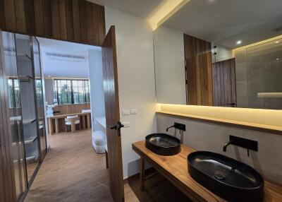 Modern bathroom with dual sinks and wooden accents