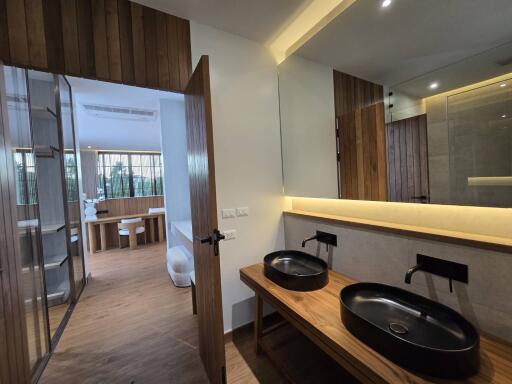 Modern bathroom with dual sinks and wooden accents