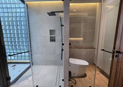 Modern bathroom with glass shower and toilet