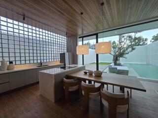 Modern kitchen with dining area and view of the pool