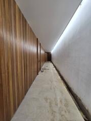 Modern hallway with wooden paneling and lighting