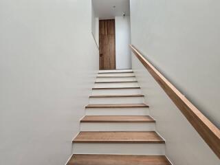 Staircase with wooden steps and handrail