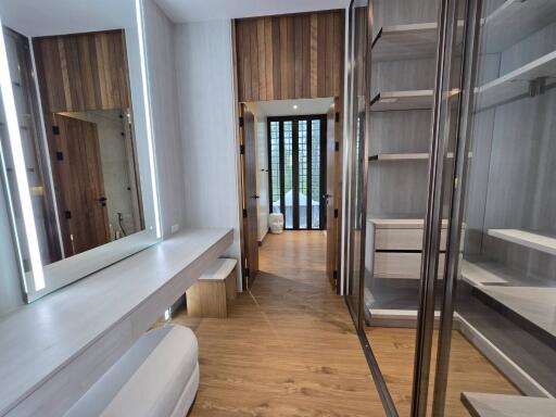 Spacious walk-in closet with modern lighting and ample storage