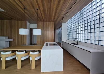 Modern kitchen with wooden elements and glass brick windows